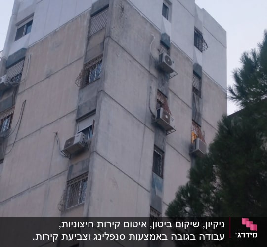 בניין גבוה עם מזגנים מותקנים על הקירות החיצוניים